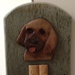 A Cute Puppy Carving on a Stone Tile