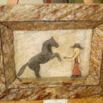 Carving of a Horse and a Woman on Stone Tile